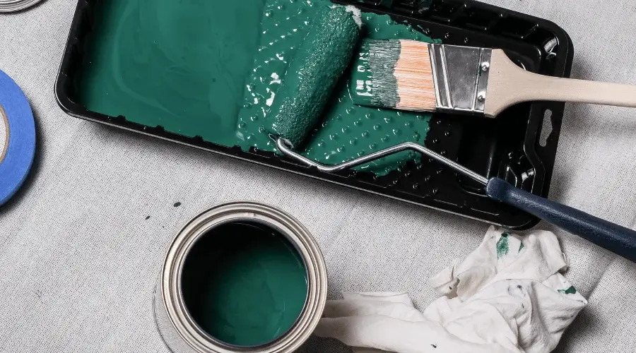 can of green paint and paint roller
