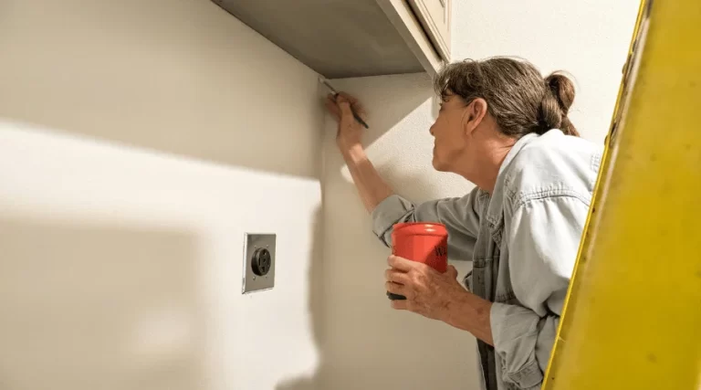 woman painting a corner